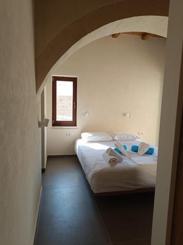 a bedroom with two beds with towels on them at Evans Villas in Gramvousá