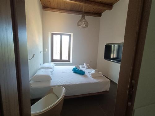 a bedroom with two beds and a window and a sink at Evans Villas in Gramvousá