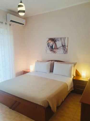 a bedroom with a bed with two white pillows at Sofia's modern apartment in Gjirokastër