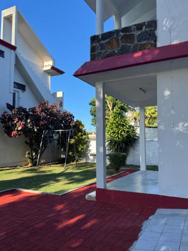 a view from the outside of a house with a patio at Transit Home Lower Level - 10 mins from Airport and Blue bay in Mare dʼAlbert