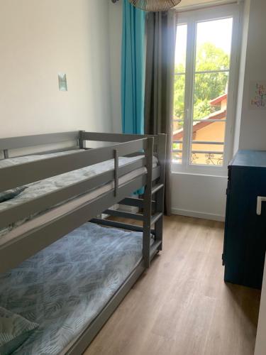 une chambre avec deux lits superposés et une fenêtre dans l'établissement Appartement 3chambres avec jardin partagé, à Loures-Barousse