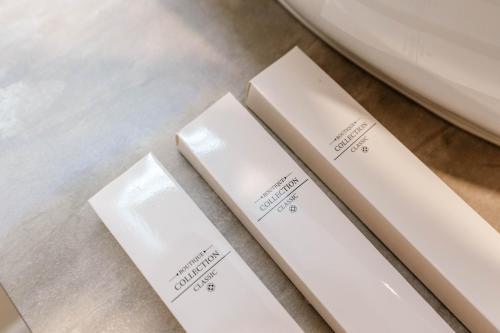 three white labels sitting on top of a table at Ermes Luxury Hotel in Durrës