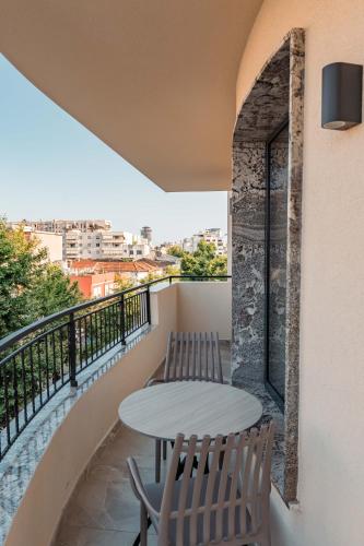 a balcony with a table and chairs and a view at Ermes Luxury Hotel in Durrës