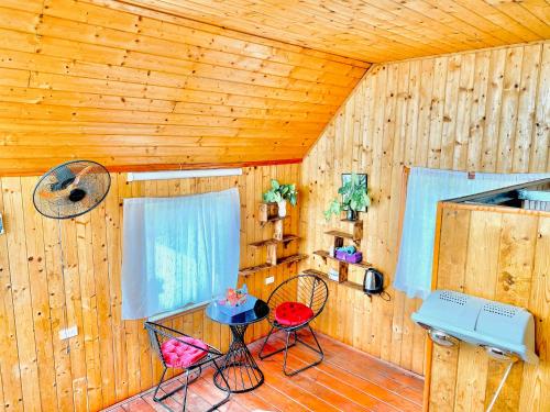 a room with a table and two chairs in a cabin at An House, Farm & Trekking in Tam Ðảo