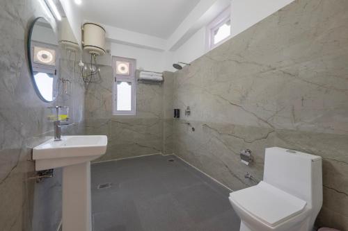 a bathroom with a sink and a toilet at Echor - The Alpine Crest in Kalpa