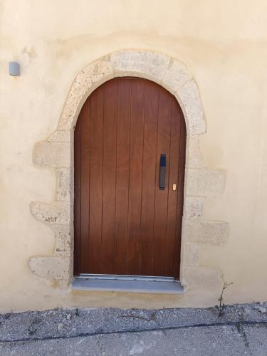a wooden door on the side of a building at Evans Villas in Gramvousá