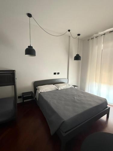 a bedroom with a bed with two lights above it at Panta Rei Camere di Charme e Spa in Taranto