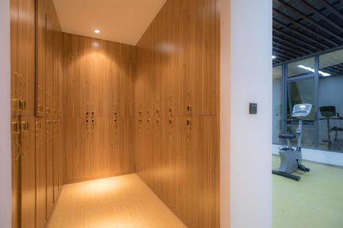 a row of wooden lockers in a room at Atour Hotel Xiamen Jimei University in Xiamen