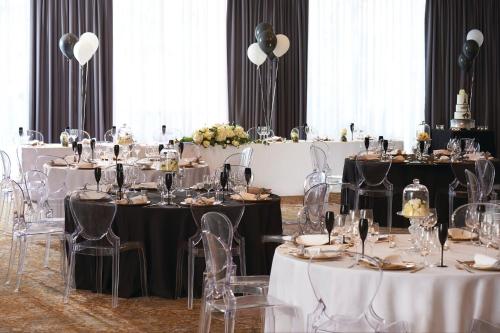 a banquet hall with tables and chairs with white tablecloths at Kimpton Charlotte Square by IHG in Edinburgh