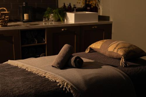 a bed with two pillows on top of it at Kimpton Charlotte Square by IHG in Edinburgh