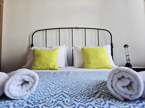 a bed with two towels on top of it at Syra & Hermes Home in Ermoupoli