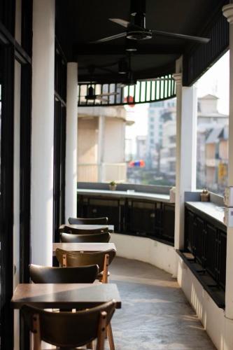 a row of tables and chairs on a balcony at Anou Hotel in Vientiane