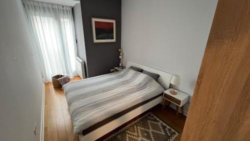 a small bedroom with a bed and a window at Lux love and family nest next to Skadarlija in Belgrade