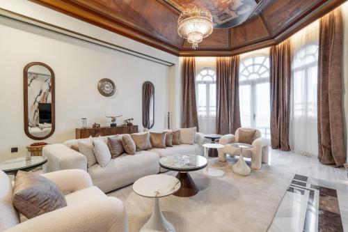 a living room with a couch and tables at Palacio Suites Marbella in Marbella