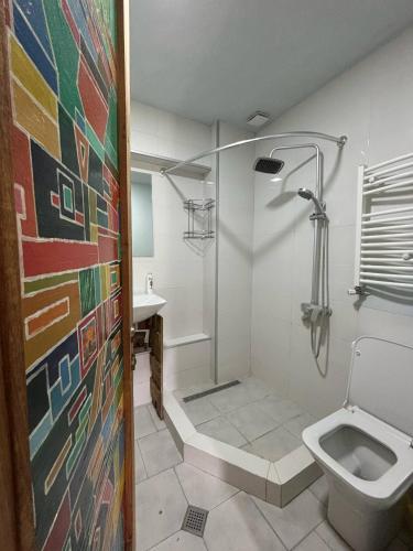 a bathroom with a shower and a toilet at Etno Rekreacia Tabatadze, With in Door & Out door pool 