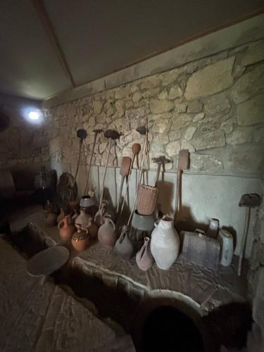 a group of vases and other items on a wall at Etno Rekreacia Tabatadze, With in Door & Out door pool 