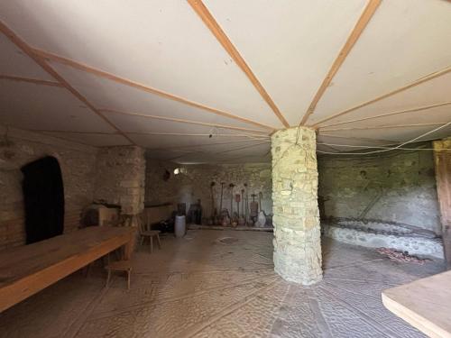a large room with a ceiling and a table and columns at Etno Rekreacia Tabatadze, With in Door & Out door pool 