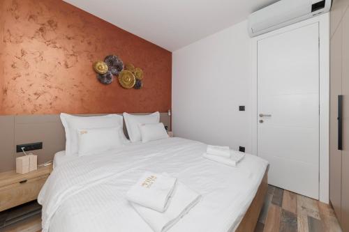 a bedroom with a large white bed with white pillows at Villa Riva Vir Apartment in Vir