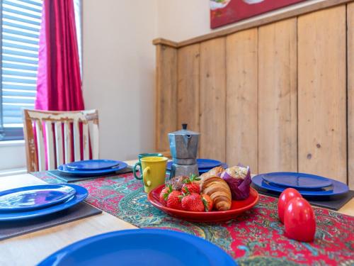 a table with a plate of food on a table at Pass the Keys Cosy Spacious Garden House in Bridgnorth