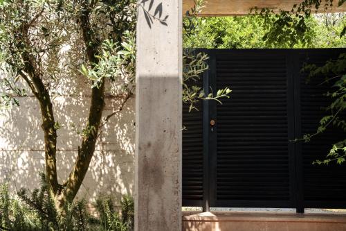 a pole with a black door in front of a building at Villa Invicta with 17m pool and bay view in Kotor