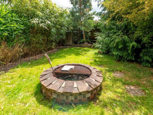 a fire pit in the grass in a yard at Pass the Keys Cosy Spacious Garden House in Bridgnorth