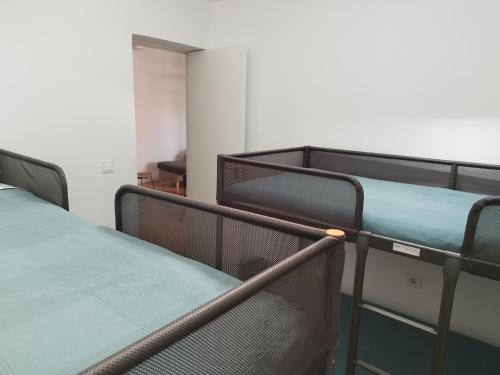 a group of beds in a room at Apartamento 4 habitaciones y 2 baños in Puerto de Sagunto