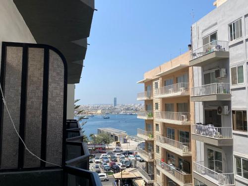 a view of a city from a balcony of a building at Sea Breeze Retreat - Comfort Apartments in the Heart of Sliema in Sliema