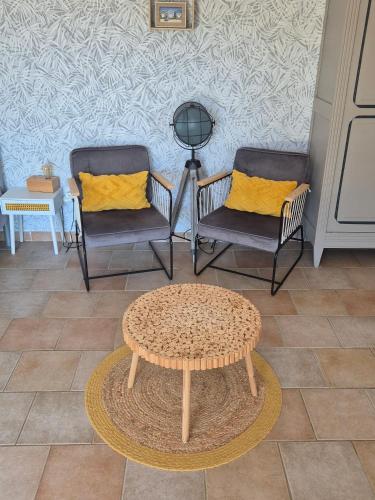 a room with two chairs and a table and a coffee table at Gites Colline De Sollies in Salernes