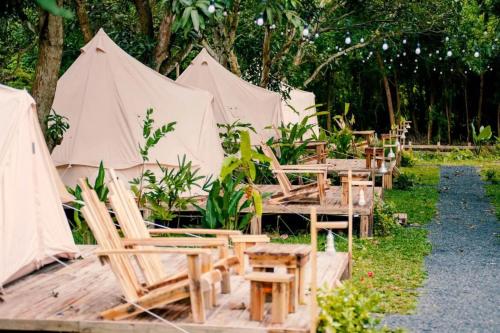 a group of tables and chairs and tents at Binifarm Tropical Retreat in Cu Chi