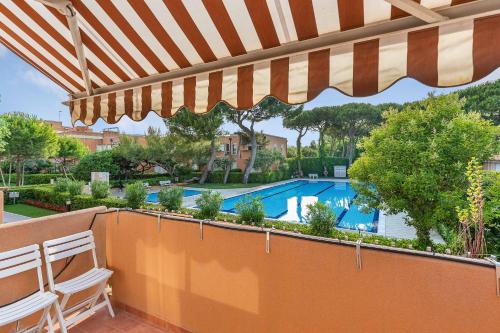 a patio with an umbrella and a swimming pool at Ca di Valle Retreats in Cavallino-Treporti