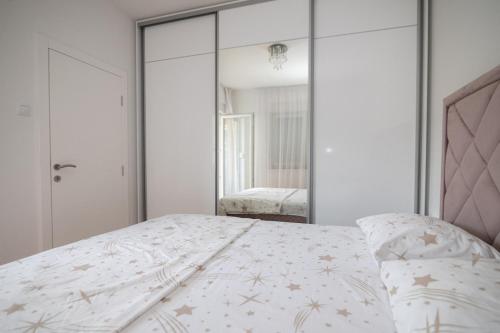 a bedroom with a bed and a mirror at Delux in Trebinje