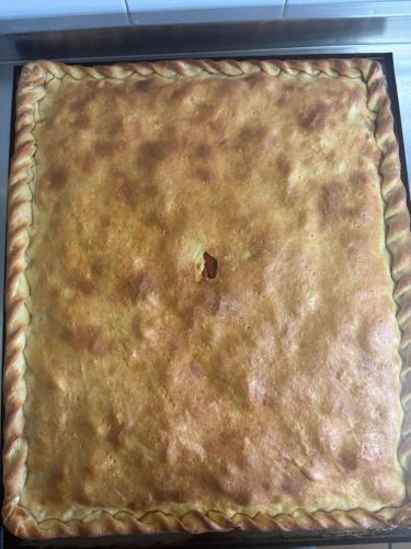 a pie crust in a pan in an oven at Hotel rural casa Ferreiro in Seoane