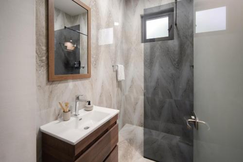 a bathroom with a sink and a shower at Villa Invicta with 17m pool and bay view in Kotor