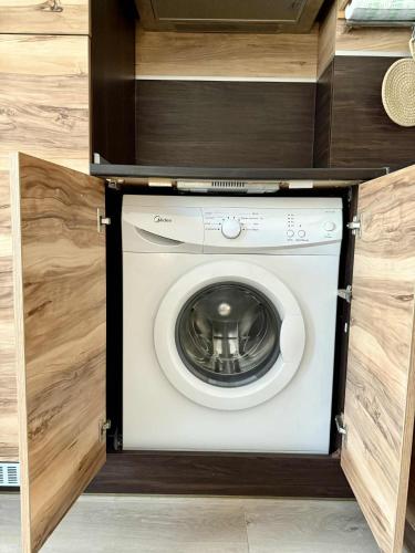 a washing machine in a cabinet in a kitchen at Studio Moré in Shkorpilovtsi
