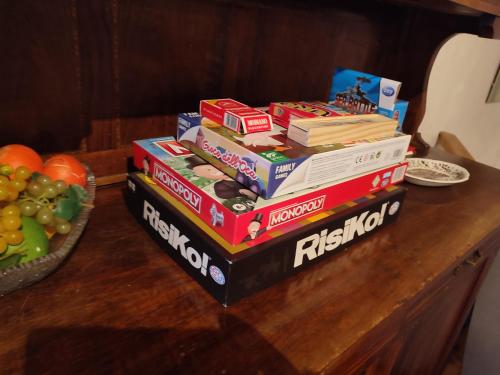 a stack of books on a table with a bowl of fruit at Tra cielo e terra in Trevi nel Lazio