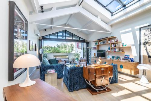 a living room with a couch and a table at Villa Elisa - Maison esprit loft 500m plage in Biarritz