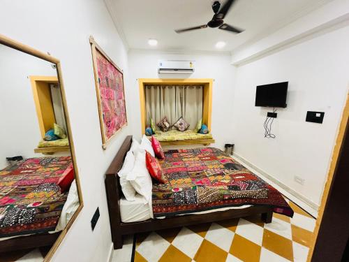 a bedroom with a bed and a mirror at Thar Tribe Hostel Jaisalmer in Jaisalmer