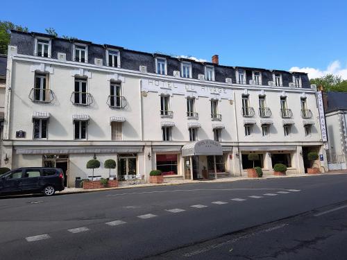 a large white building on the side of a street at Logis Hôtel Le Rivage in Gien