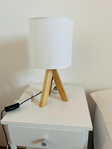 a table with a lamp on a bedside table at Casa Vacanze "A Machina Ro Ghiaccio" in Noto