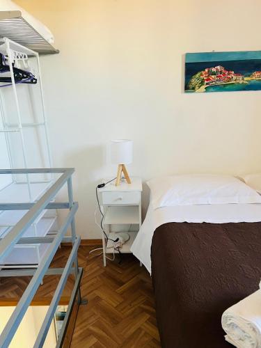a bedroom with a bed and a ladder and a desk at Casa Vacanze "A Machina Ro Ghiaccio" in Noto