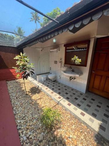 a bathroom with a toilet and a sink at Abad Whispering Palms in Kumarakom