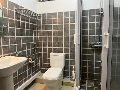 a bathroom with a toilet and a sink at Fortuna Beach in Flic-en-Flac