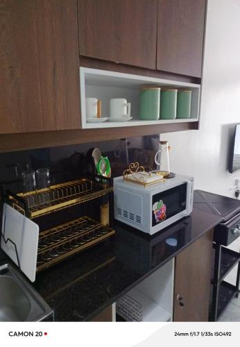 a kitchen with a counter top with a microwave at Heavenly Castles in Ongata Rongai 