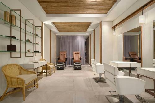 a waiting room with chairs and desks and tables at Renaissance Danang Hoi An Resort & Spa in Hoi An