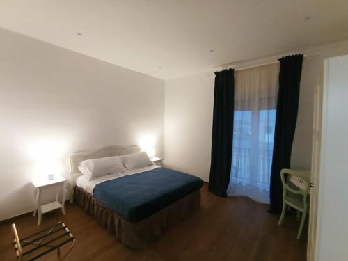a small bedroom with a bed and a window at Calì eventi room in Torre del Greco