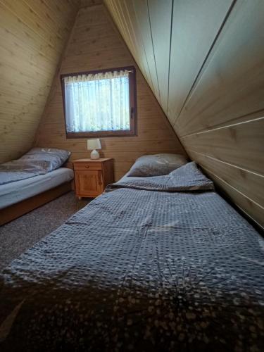 a bedroom with two beds in a tent at Domek u Marty in Solina