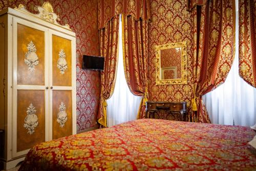 a bedroom with a bed and a mirror and curtains at Hotel Giorgione in Venice