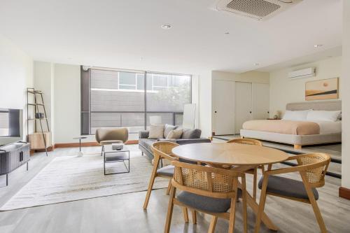 a living room with a bed and a table and chairs at Blueground Waterfront view nr Long Beach LAX-1365 in Los Angeles