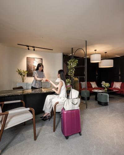 two women sitting at a counter in a hotel room at Express by M Village Nguyễn Bỉnh Khiêm in Ho Chi Minh City