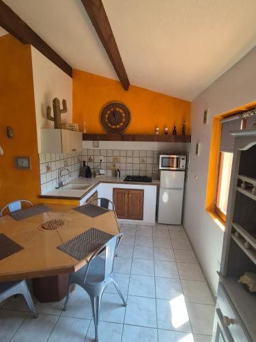 a kitchen with a table and a dining room at Gites Colline De Sollies in Salernes